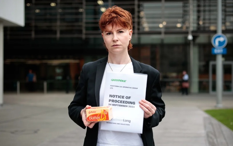 Greenpeace's Sinéad Deighton-O'Flynn serving Fonterra with the dairy company the lawsuit, in...