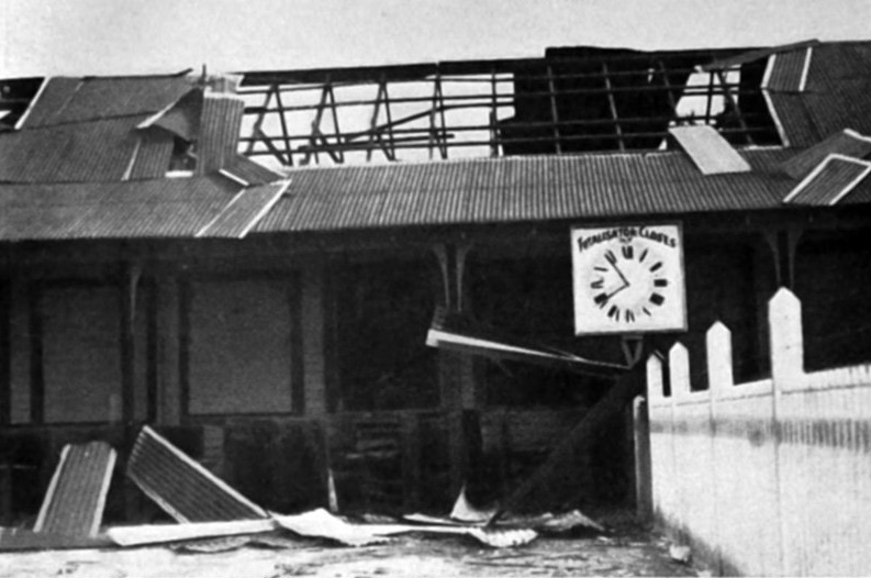 The aftermath of an explosion at Avondale racecourse: the wrecked totalisator building. — Otago...