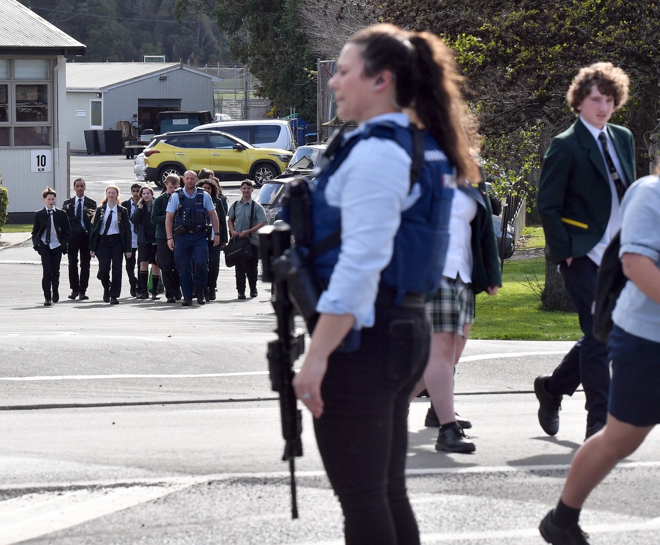 Armed police escort students from the grounds of Bayfield High School which was closed after an...