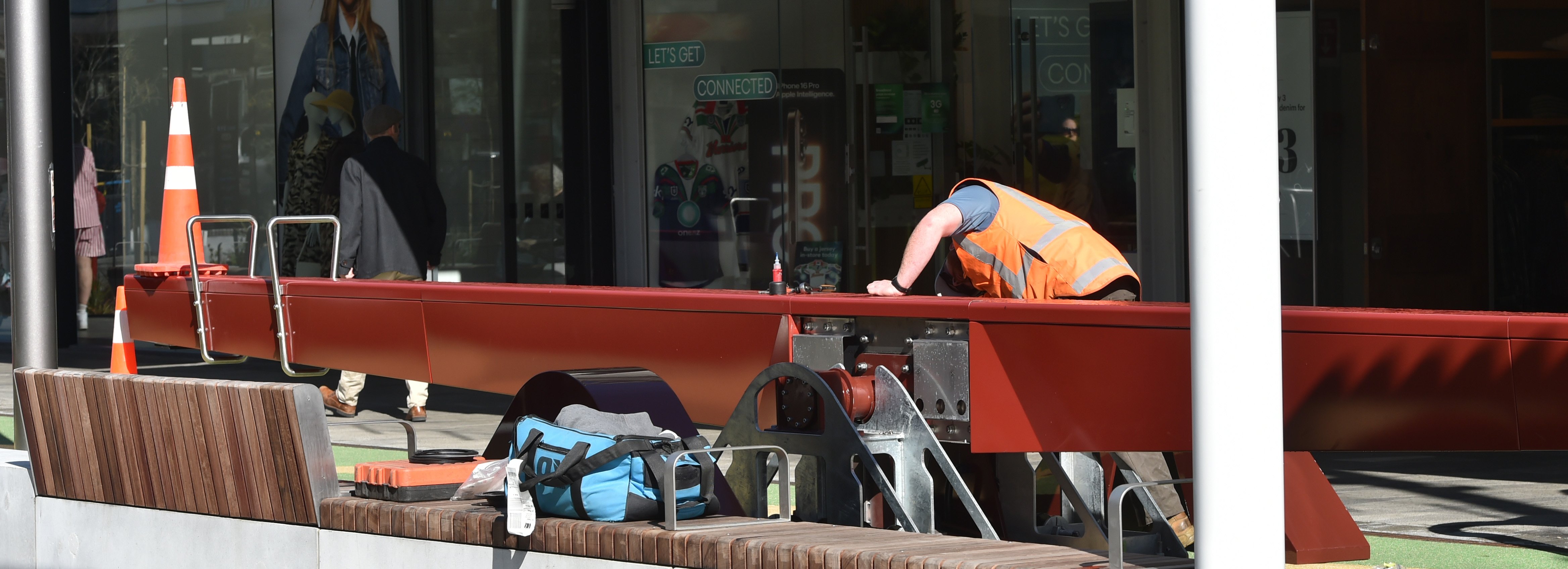 A contractor examines one of three seesaws yesterday, installed as part of upgrades to George St...