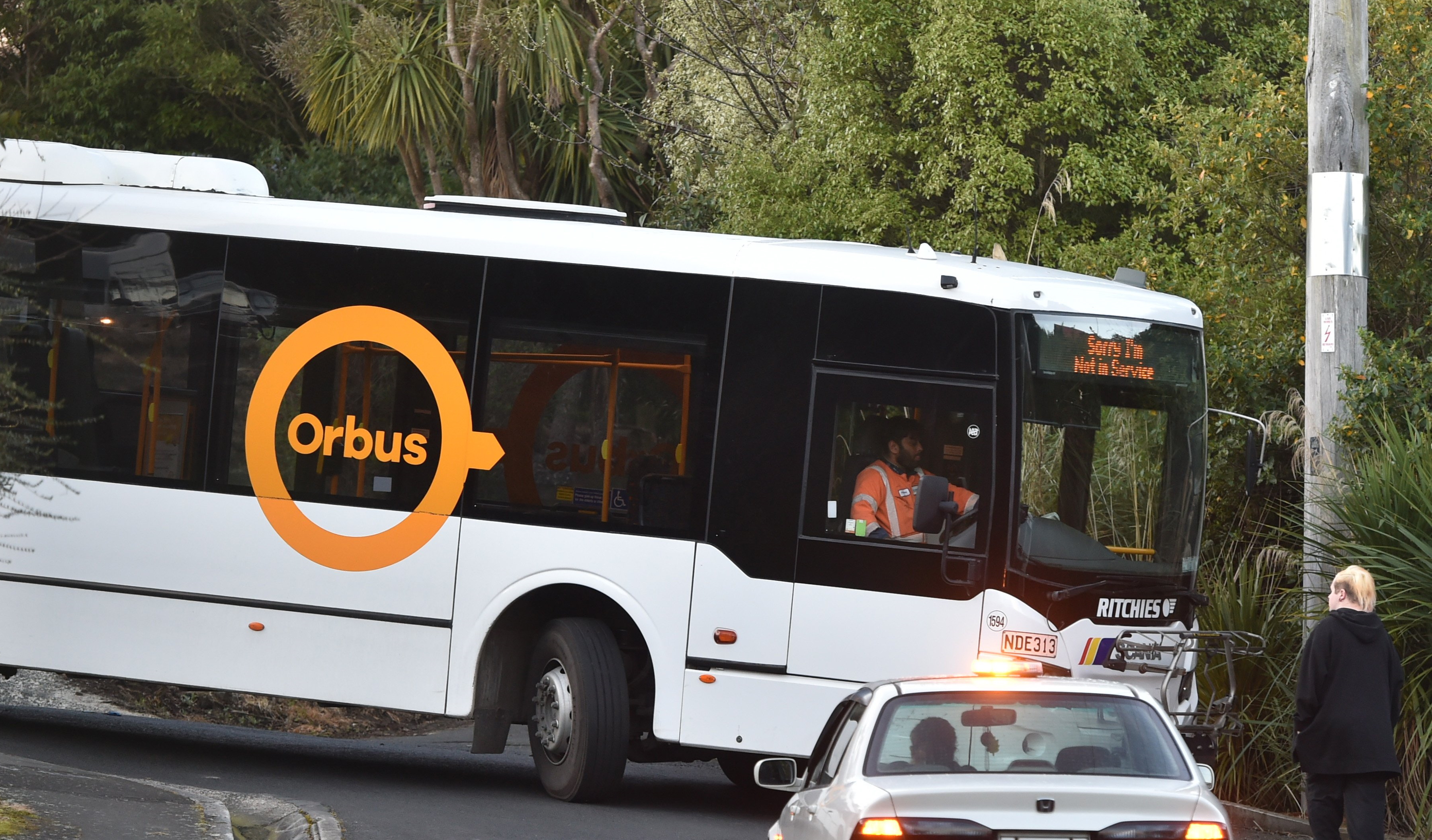 A worker attempts to manoeuvre the bus out of its tight spot. Photo: Gregor Richardson