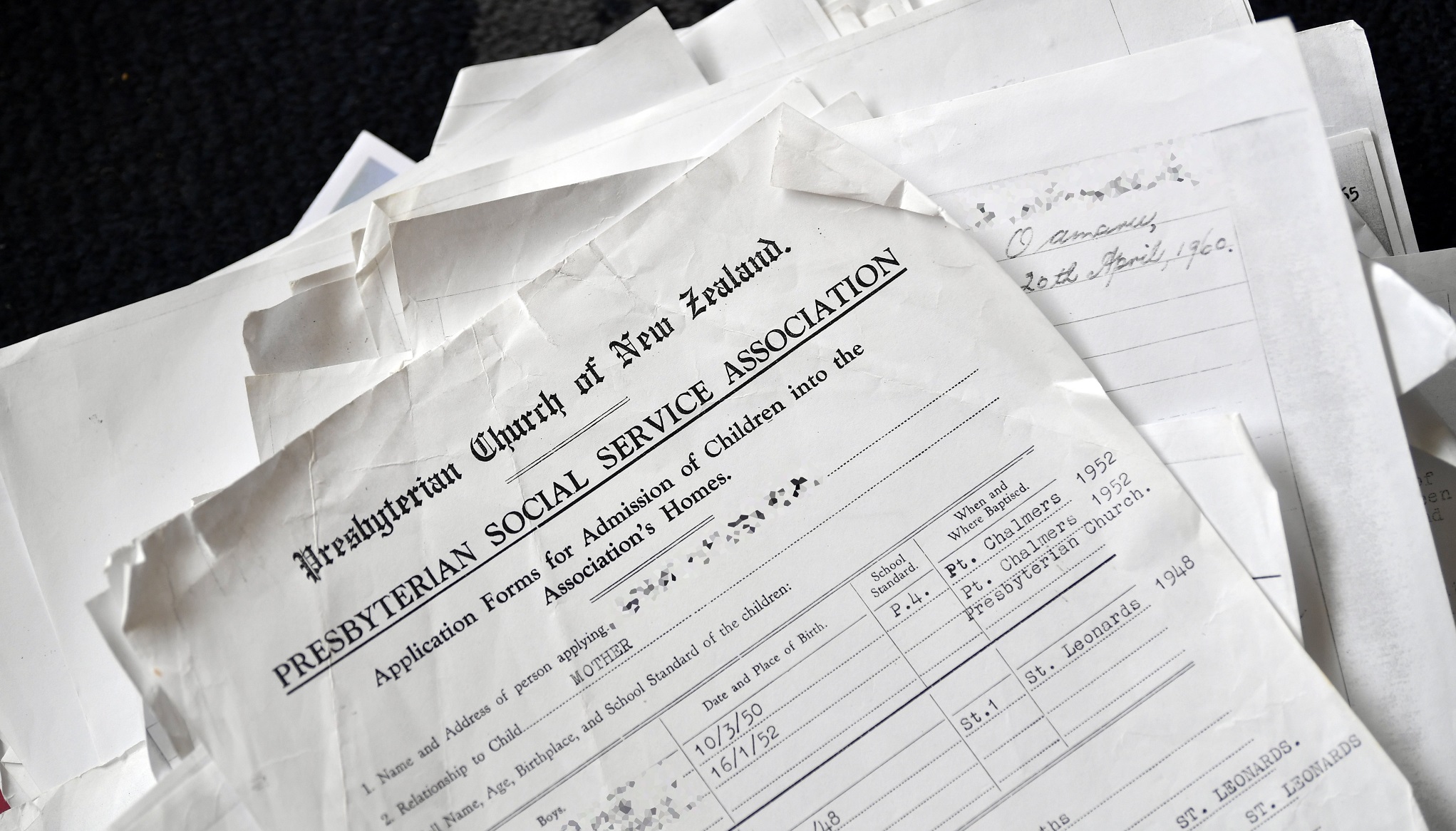 A rag-tag pile of paperwork stacks up to be one of the children’s files released before PSO...