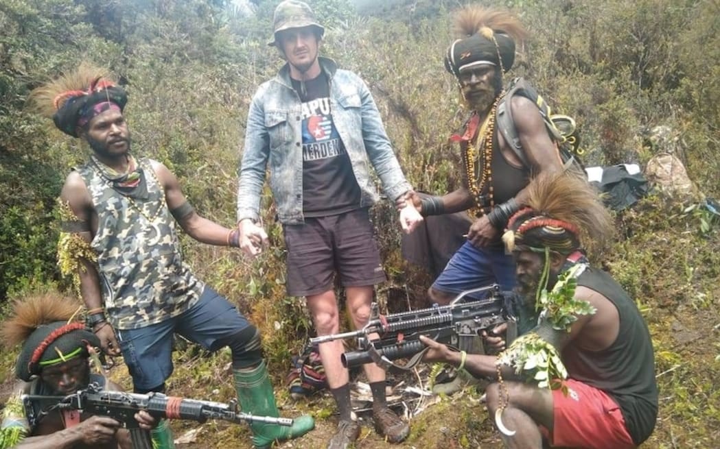 New Zealand pilot Philip Mehrtens was photographed with his rebel captors in Indonesia's Papua...