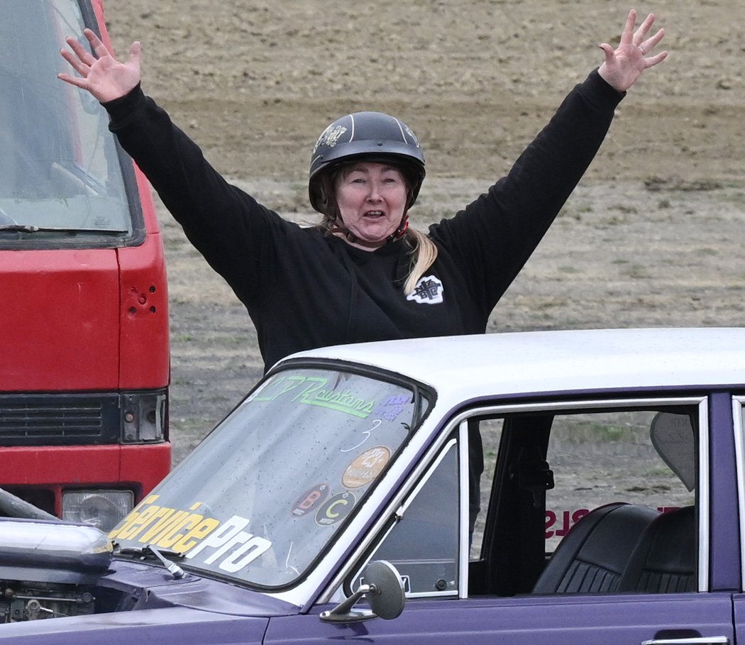 She celebrates being the first one of the day to need her car towed off the track.