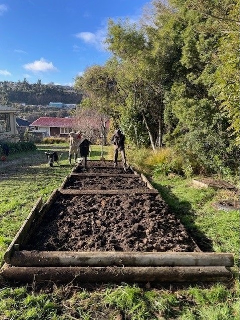 Volunteers finish the cleanup of the raised garden beds at Bradford School. Photo: supplied