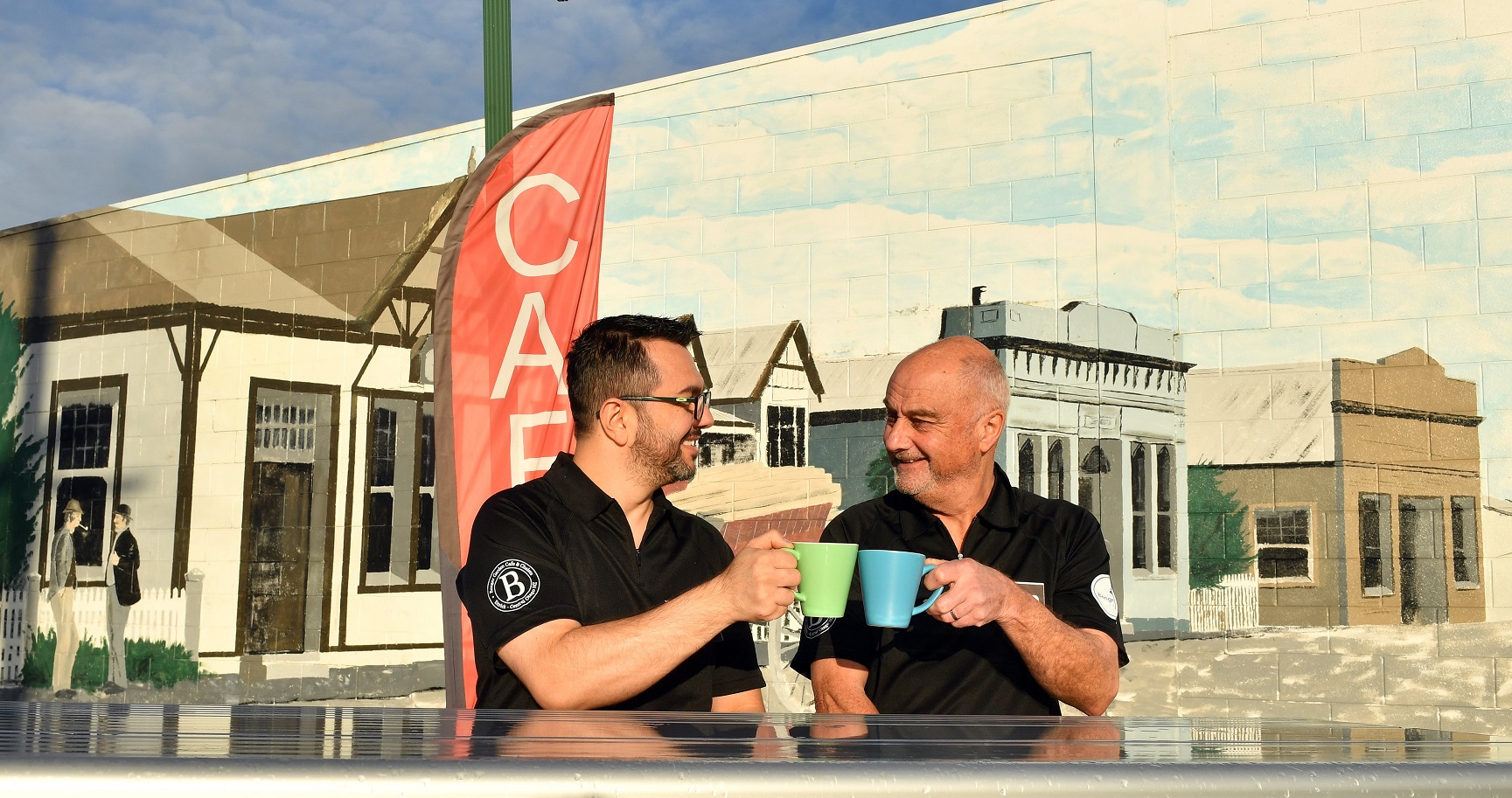 Leandro Massariolo (left) and John Tomkins celebrate opening the only cafe in Tapanui. Photo:...