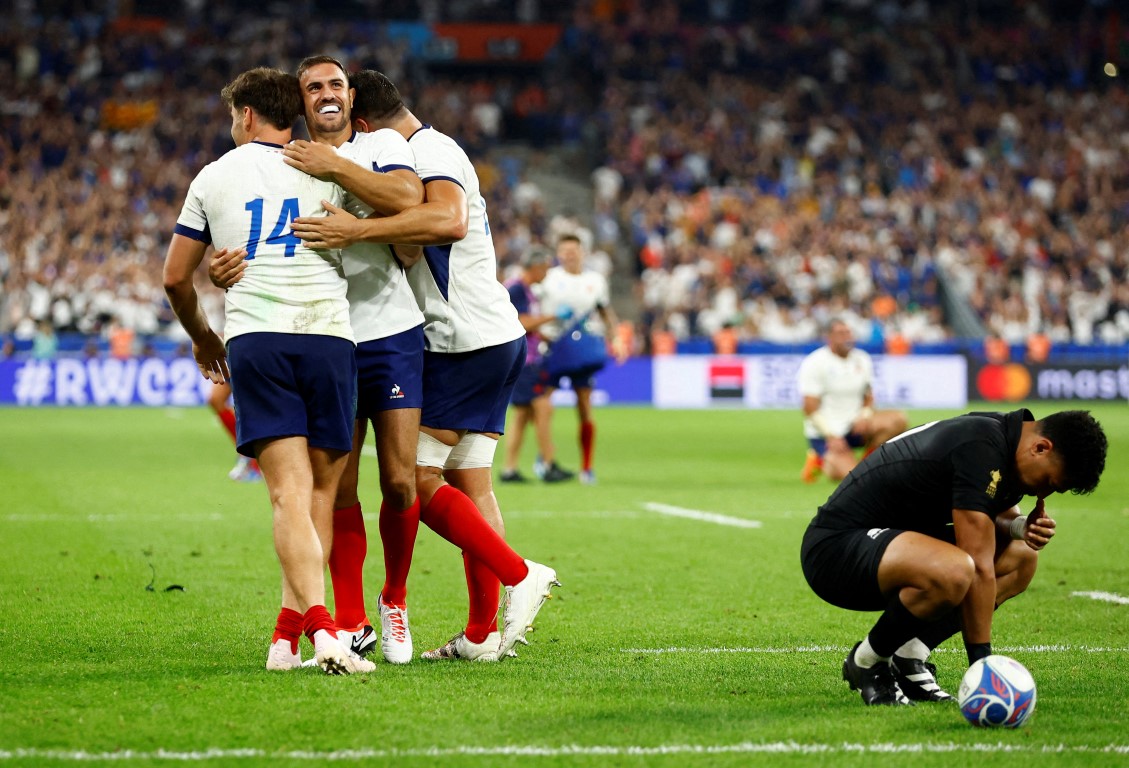 France's Melvyn Jaminet celebrates scoring their second try with teammates Damian Penaud and Paul...