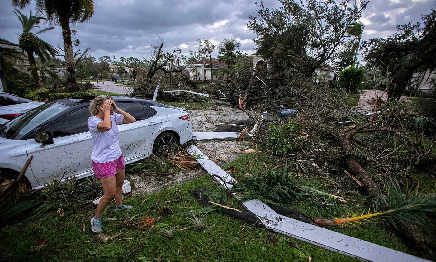 Marie Cook reacts to the damage to her home in the Binks Estates community after a tornado formed...