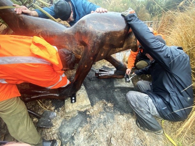 Volunteers Ben and John assisting operations team staff while installing the repaired moa statue. 