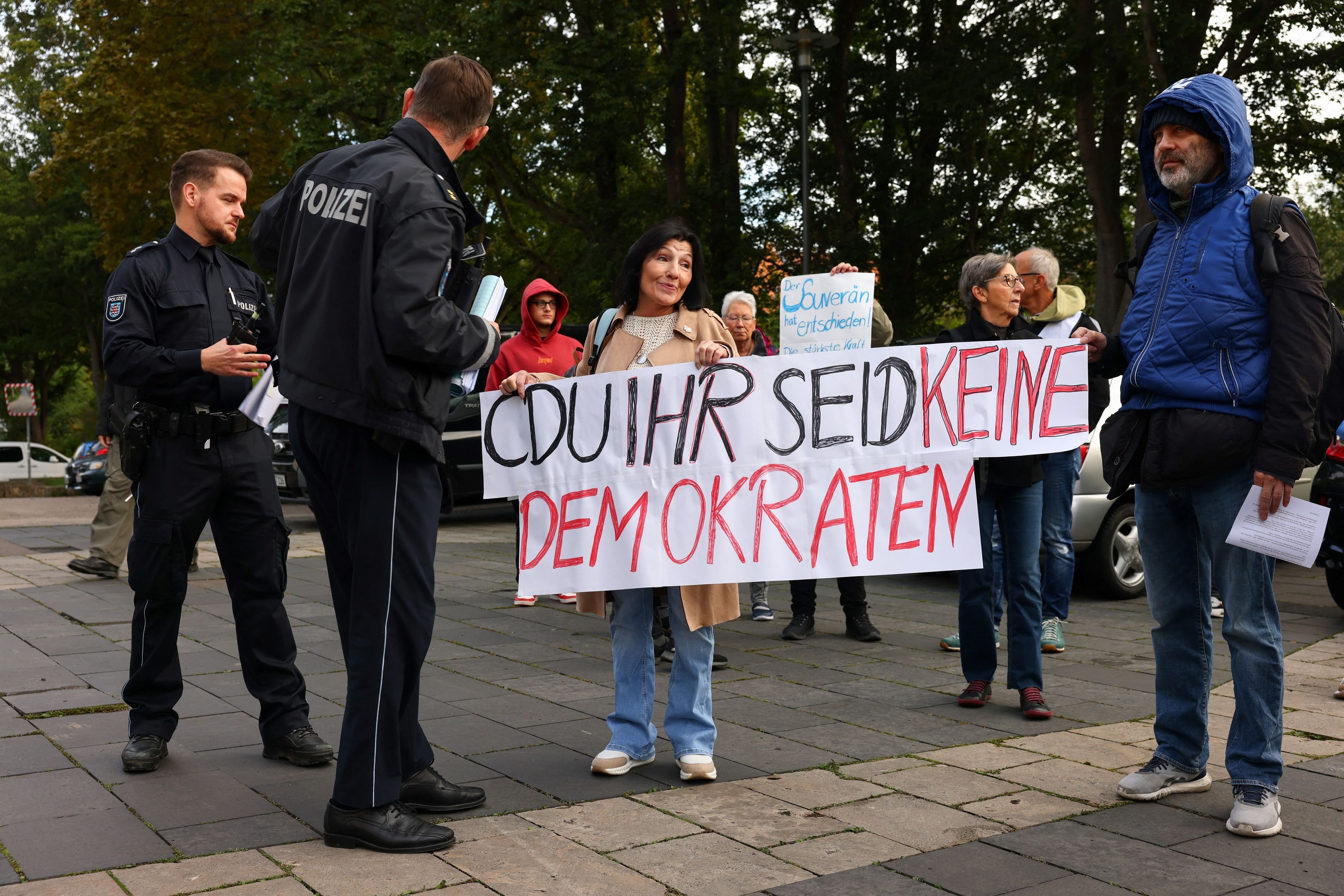 Germany’s Alternative for Germany (AfD) supporters hold signs outside the Thuringian State...