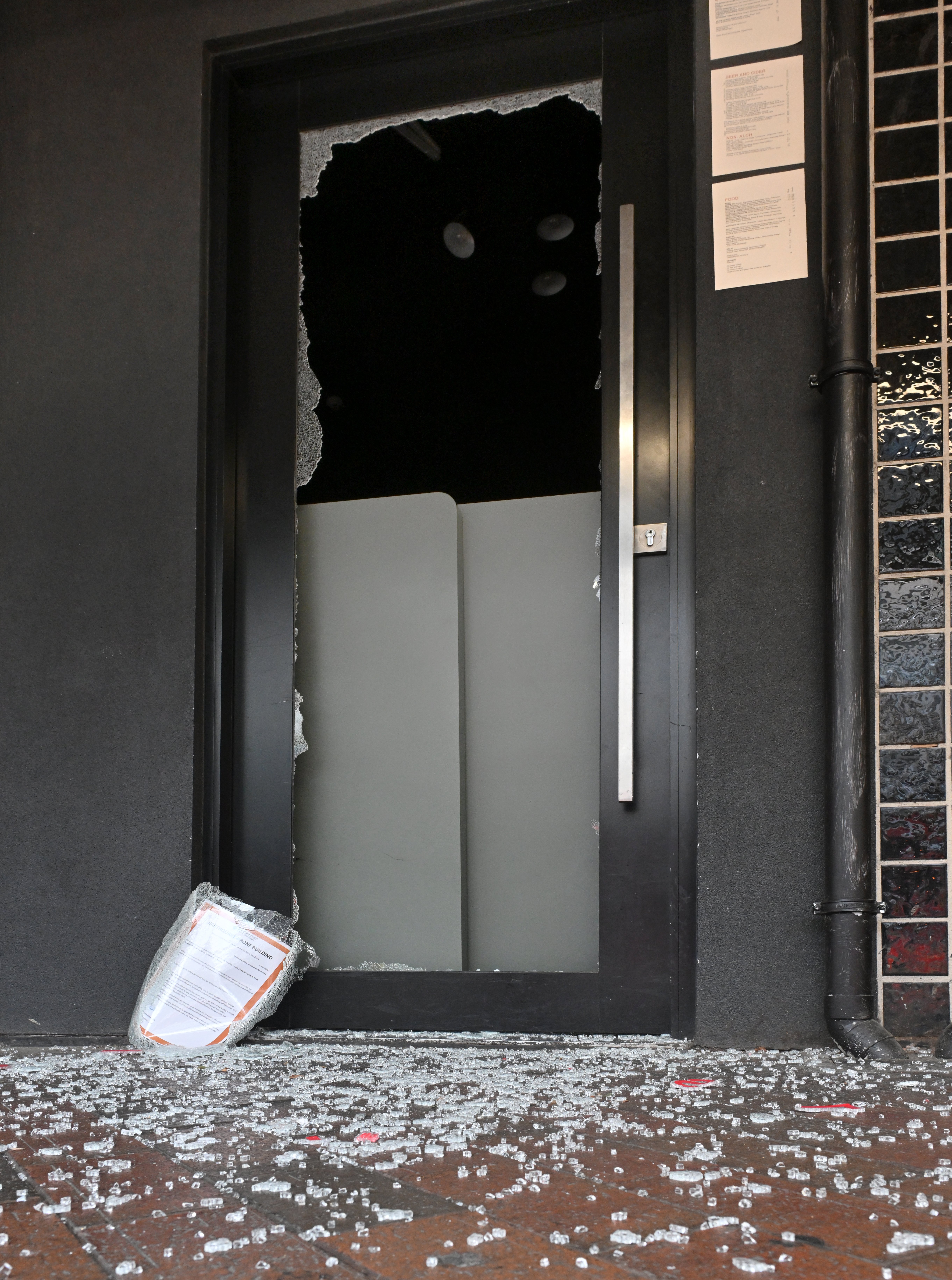 A smashed glass door in Lower Stuart St this morning. Photo: Gerard O'Broen