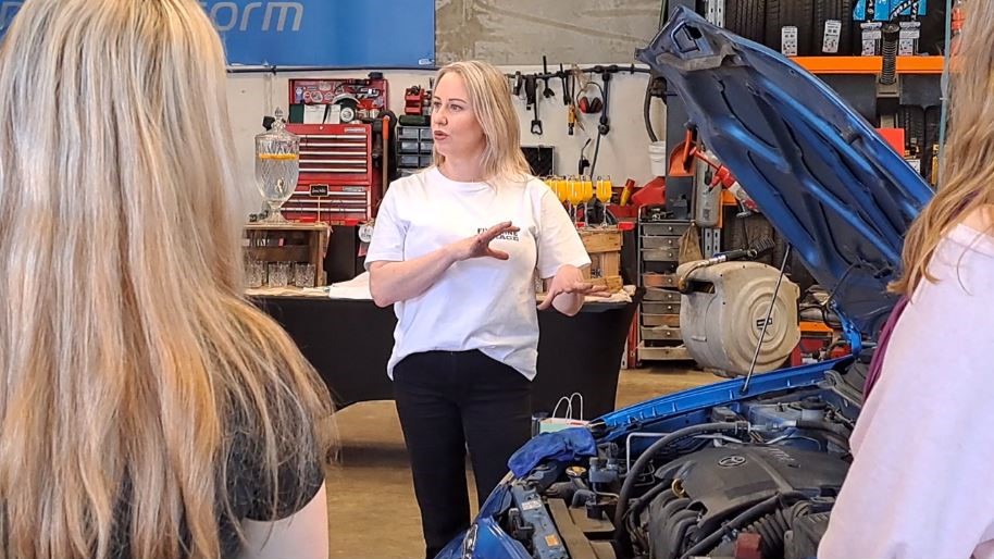 Girls 'N' Gasoline founder Melissa Hannan explains how to check oil levels on a vehicle, during a...