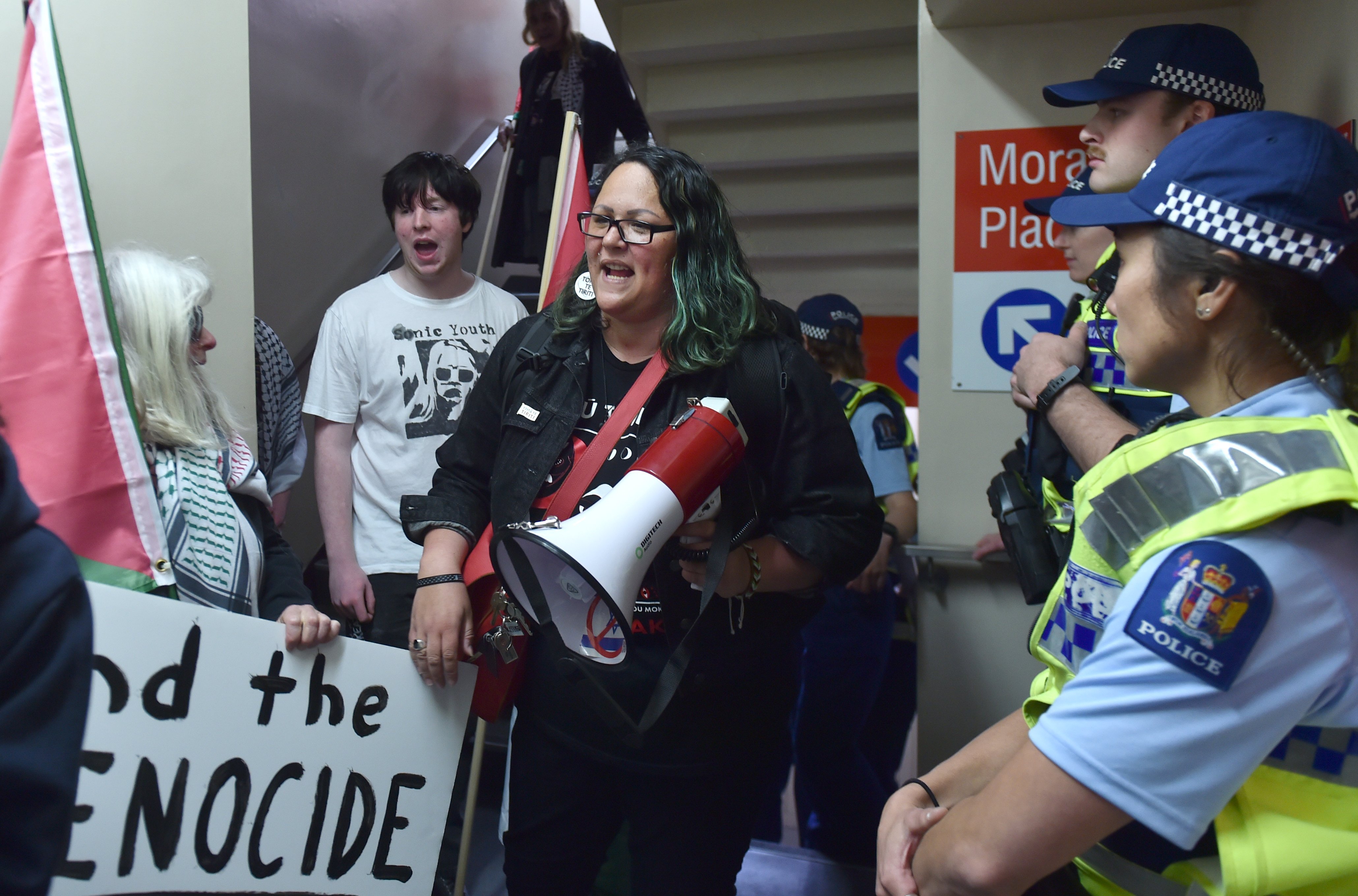 Police keep a close eye on vocal protesters during the Prime Minister's whistle-stop visit to...