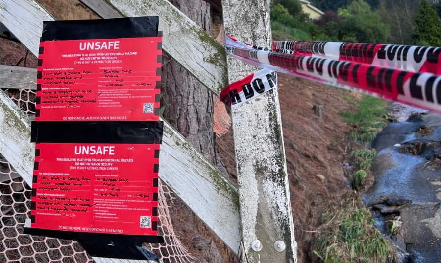 A red sticker at the boundary of a Dunedin property on 7 October after massive downpours caused...