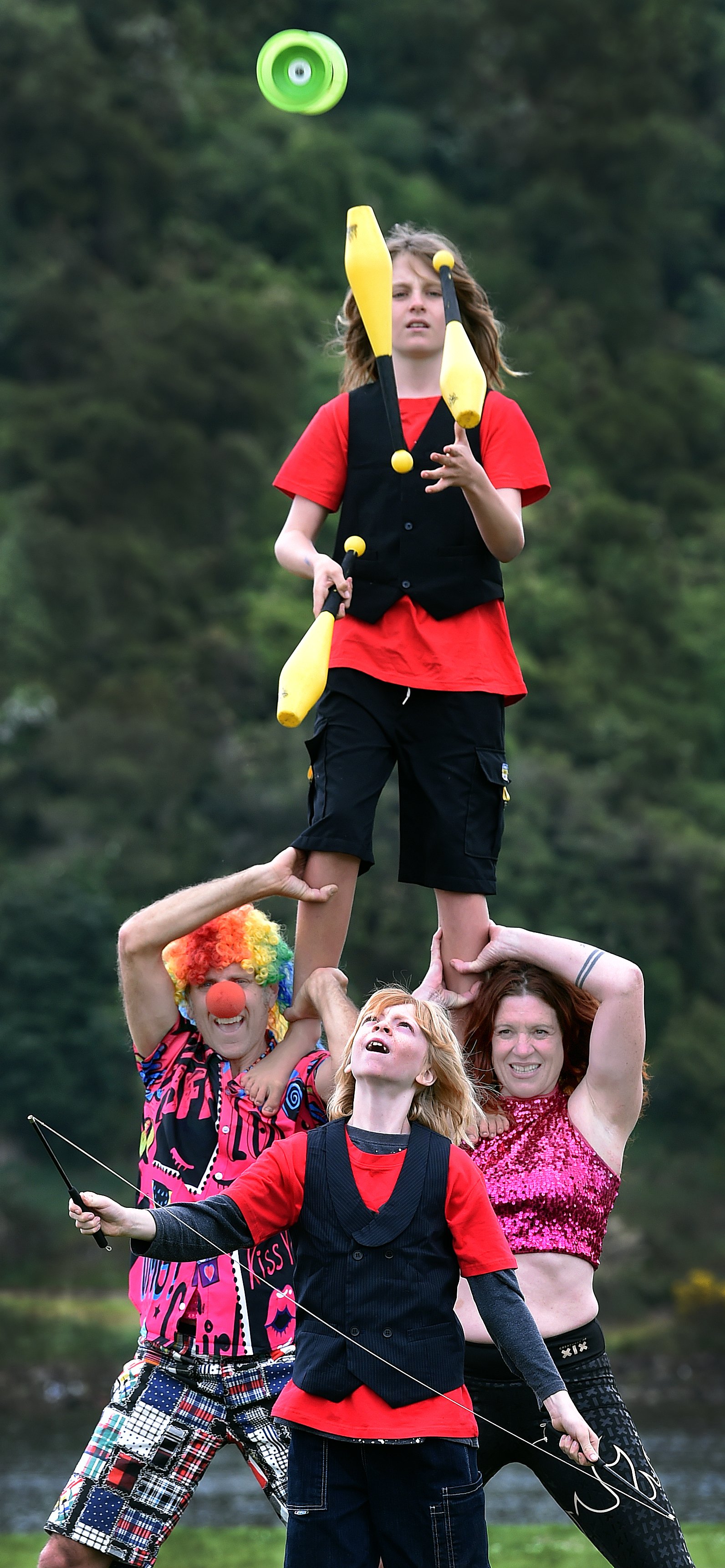 Ashton Family Circus parents Royce and Anna Ashton support their son Jaz (11) on top of their...