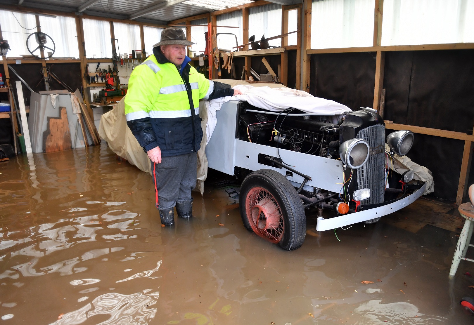 South Dunedin resident Stu Campion standing with his surviving vintage car after his garage was...