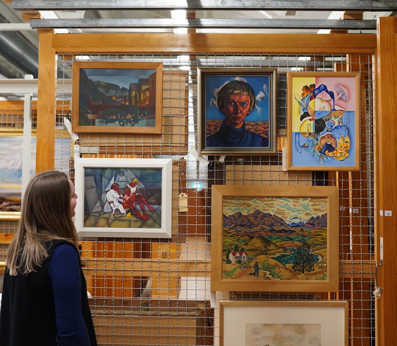 Hope Wilson, curator of art, Hocken Collections, with works by Rita Angus in the Hocken art stack...