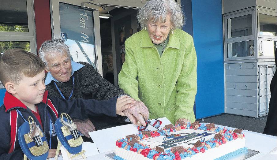 Betty Thomas, nee Brick, and Craig McIntosh, the oldest past pupils, cut the commemorative cake...