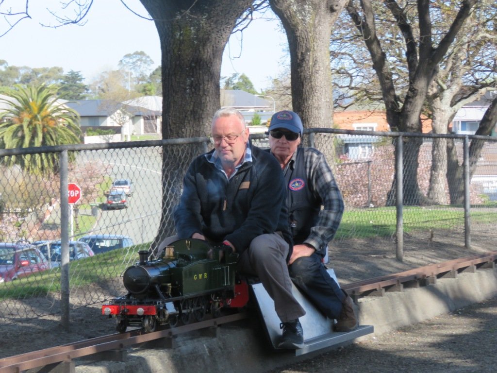 Robin Jacobs (left) and Warren McKenzie take a steam locomotive for a spin at the club’s 90th...