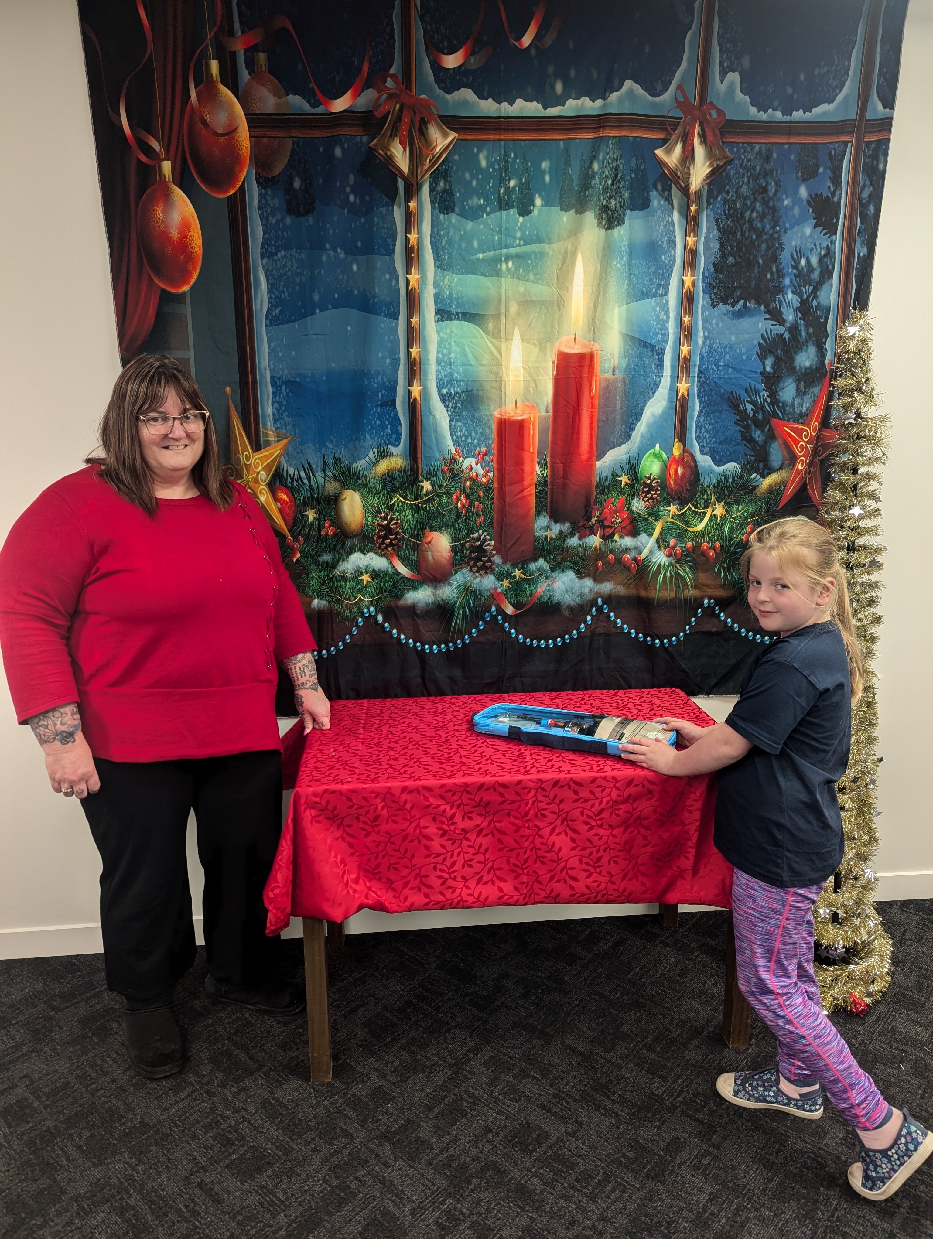 Lyn Stringer and Mya Faass, 8, set up the table at the Waimate District Council reception area...