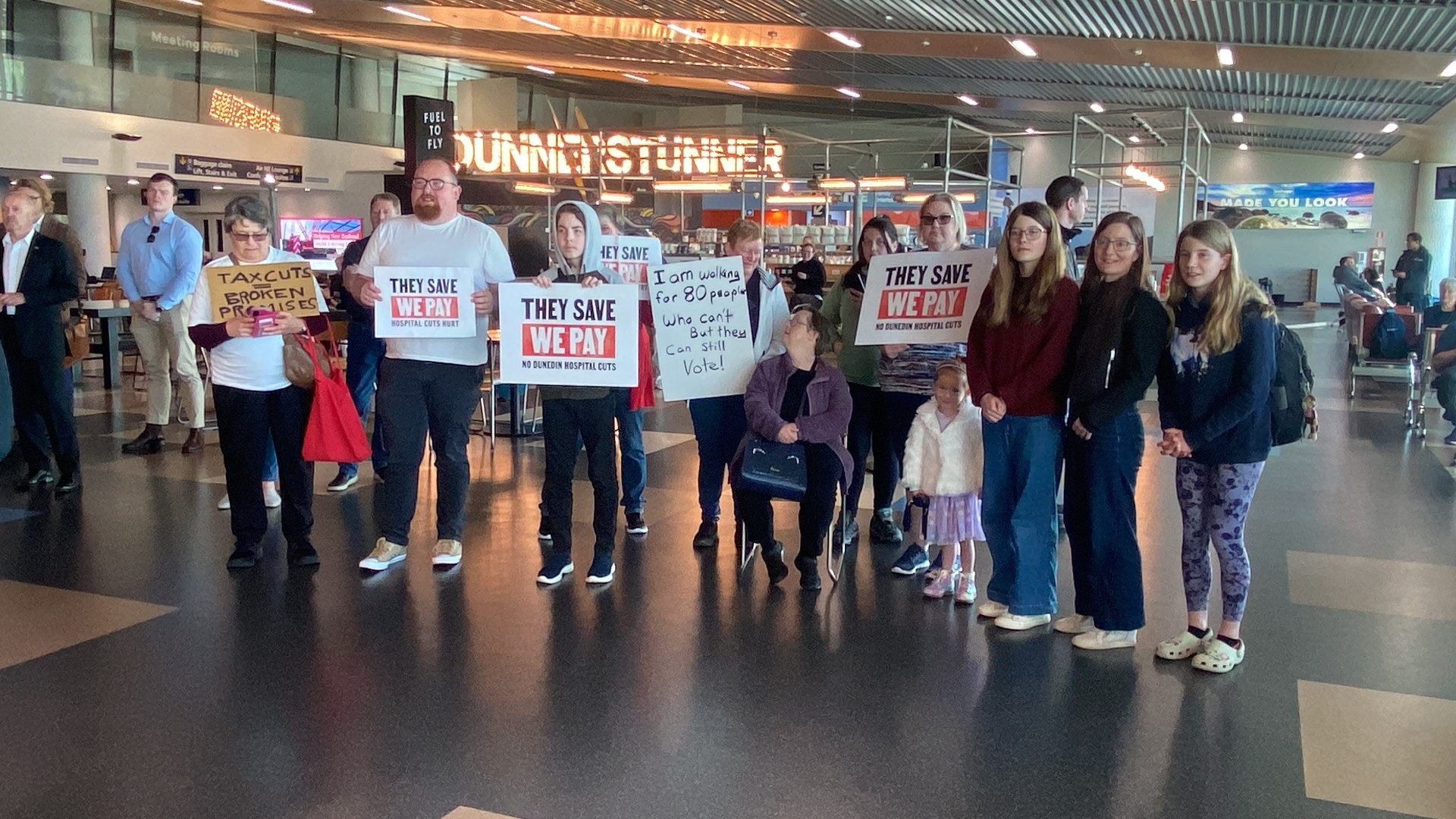 Protesters await the arrival of the Prime Minister at Dunedin Airport this morning. Photo: Craig...