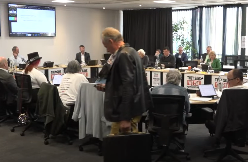 Lee Vandervis walk out of the meeting. Photo: Screenshot