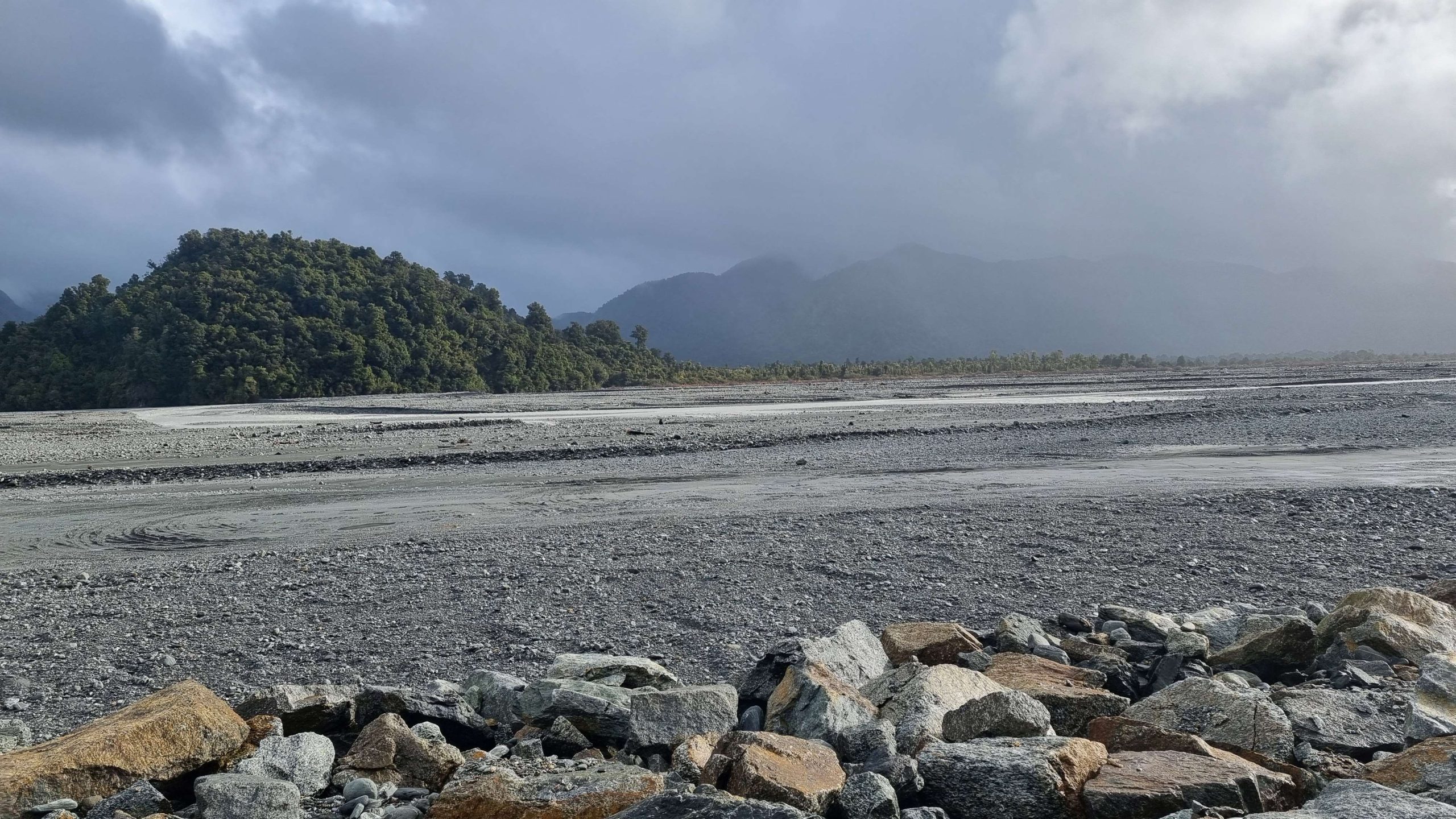 The vast rocky plain that is the bed of the Waiho River. The old Franz Josef rubbish dump lies in...