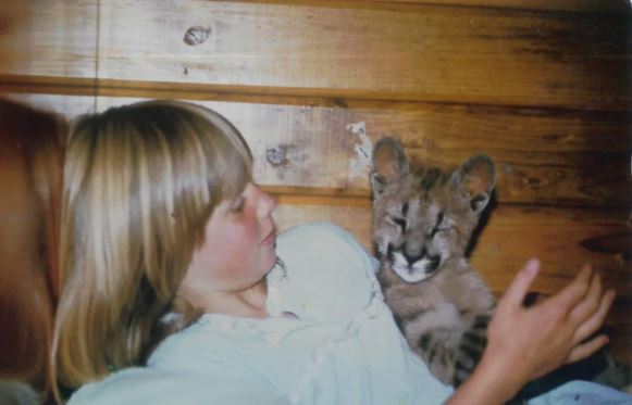 Kirsty Willis with a young lion. Photo: Supplied / Willowbank