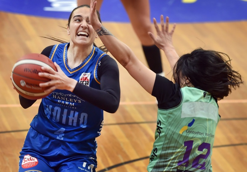 So close ... Chelsea D’Angelo puts the ball up under the pressure of Tokomanawa Queens player...