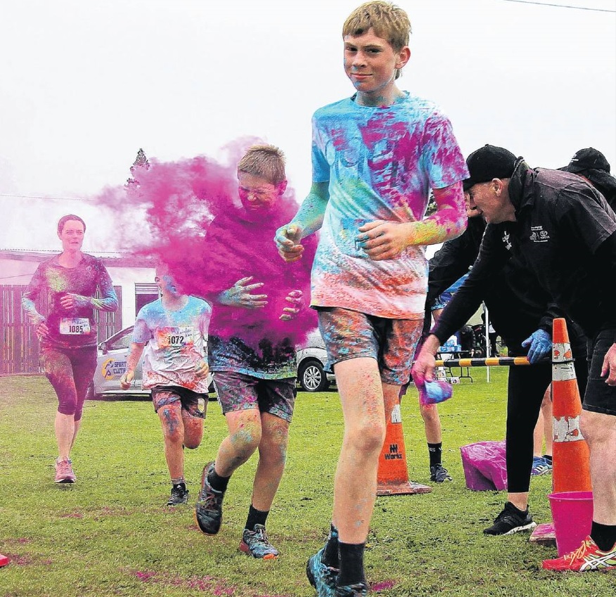 Balclutha Rainbow runners brave the last paint station before the finish line. PHOTO: NICK Brook