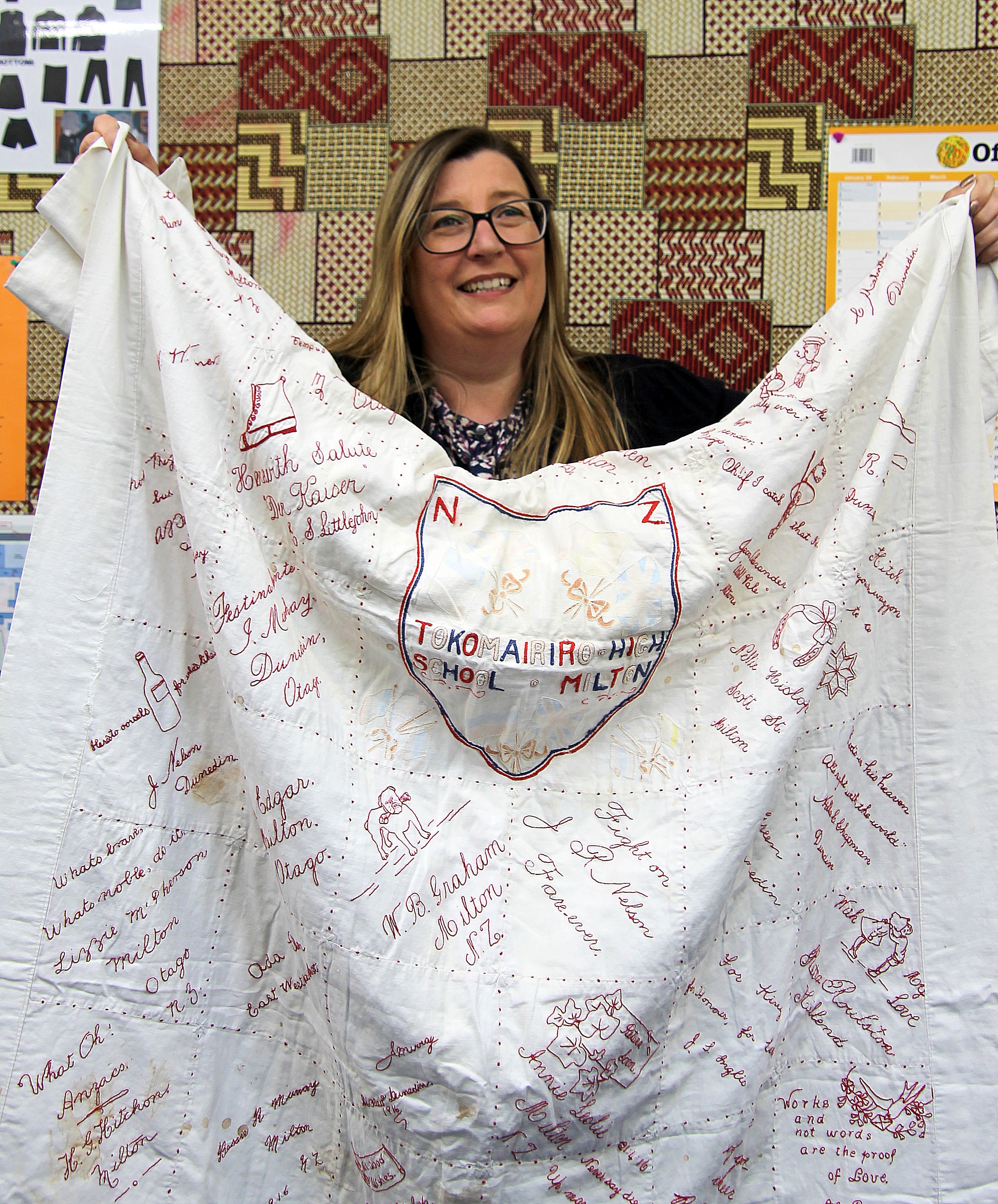 Tokomairiro High School principal Vicki Wish unpacks an antique quilt that has returned home...