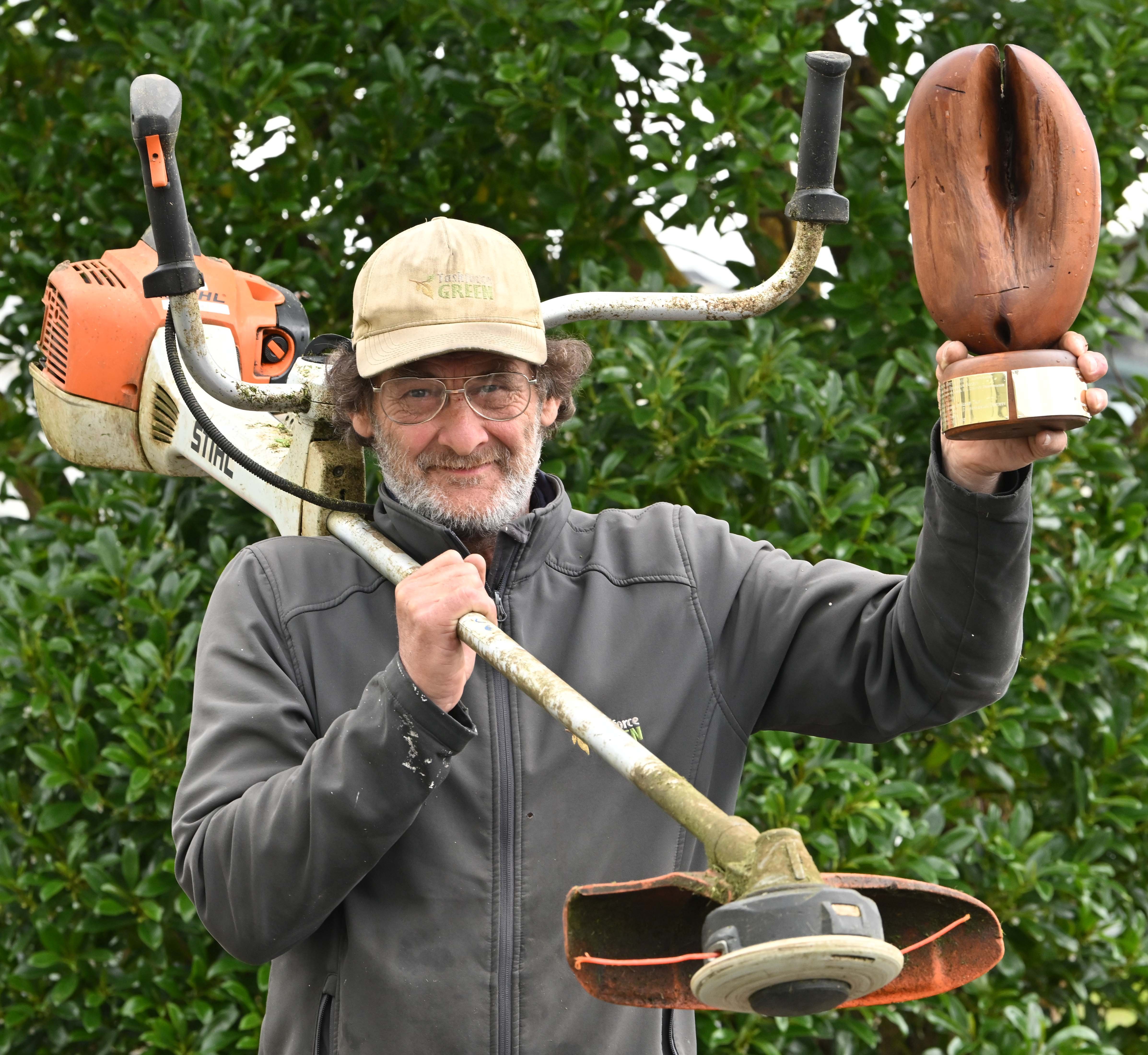 Task Force Green volunteer David Robins holds The Pod trophy he was awarded at the Keep Dunedin...