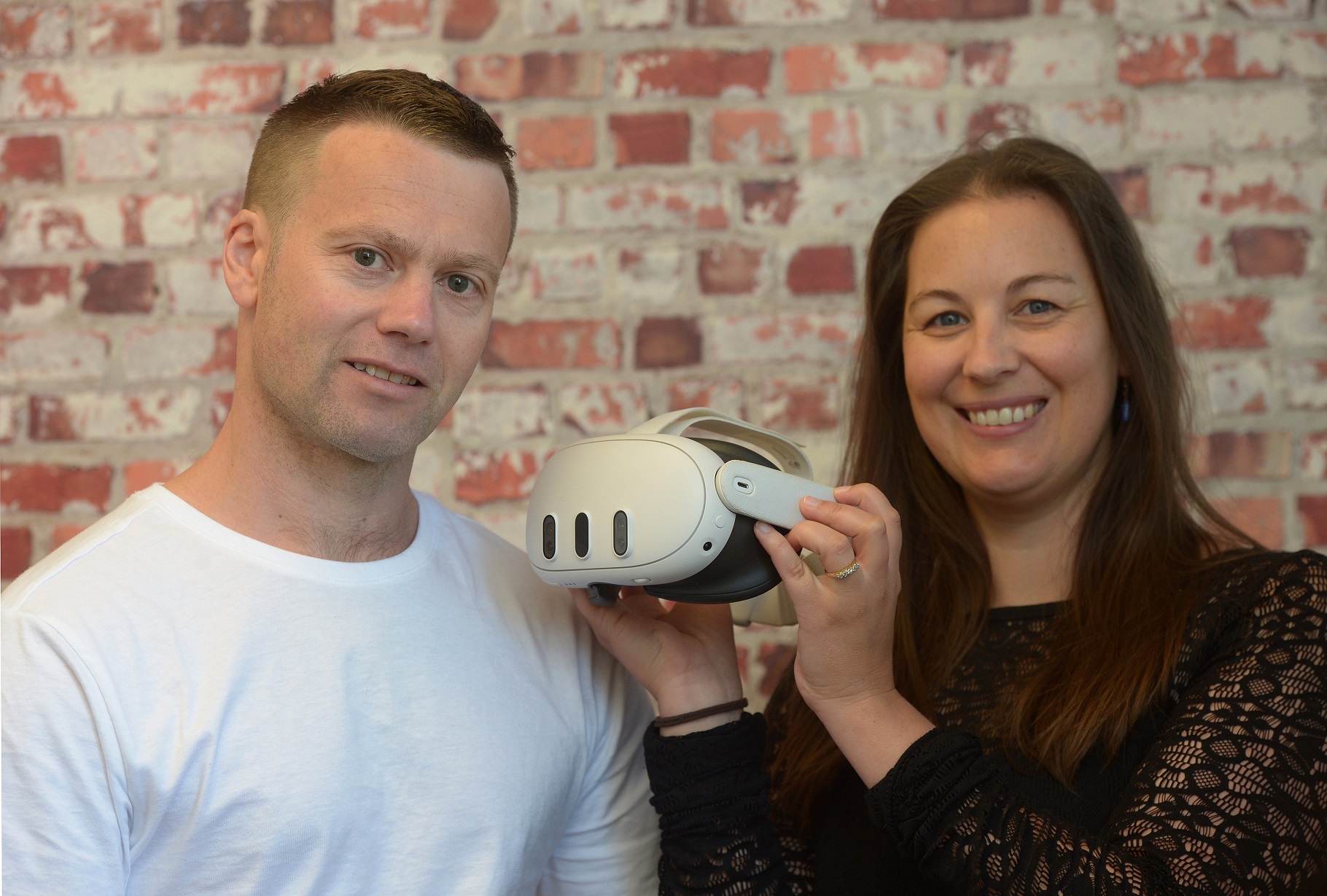 Gfactor co-founders Rhys Gardner and Claire Paterson with a headset used for their VR driving...