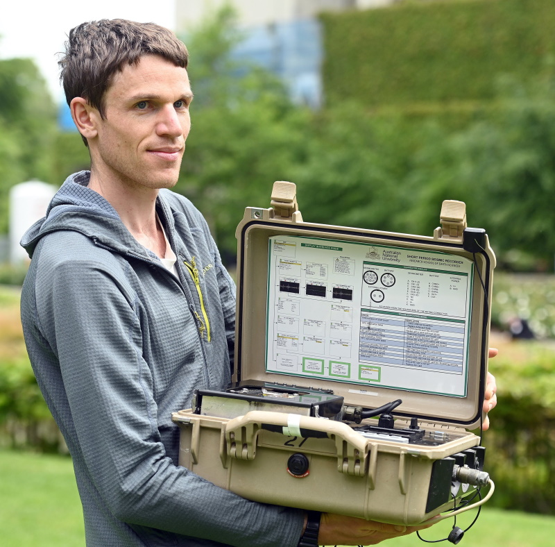 University of Otago geology postdoctoral fellow Jack Williams demonstrates a seismometer, used...