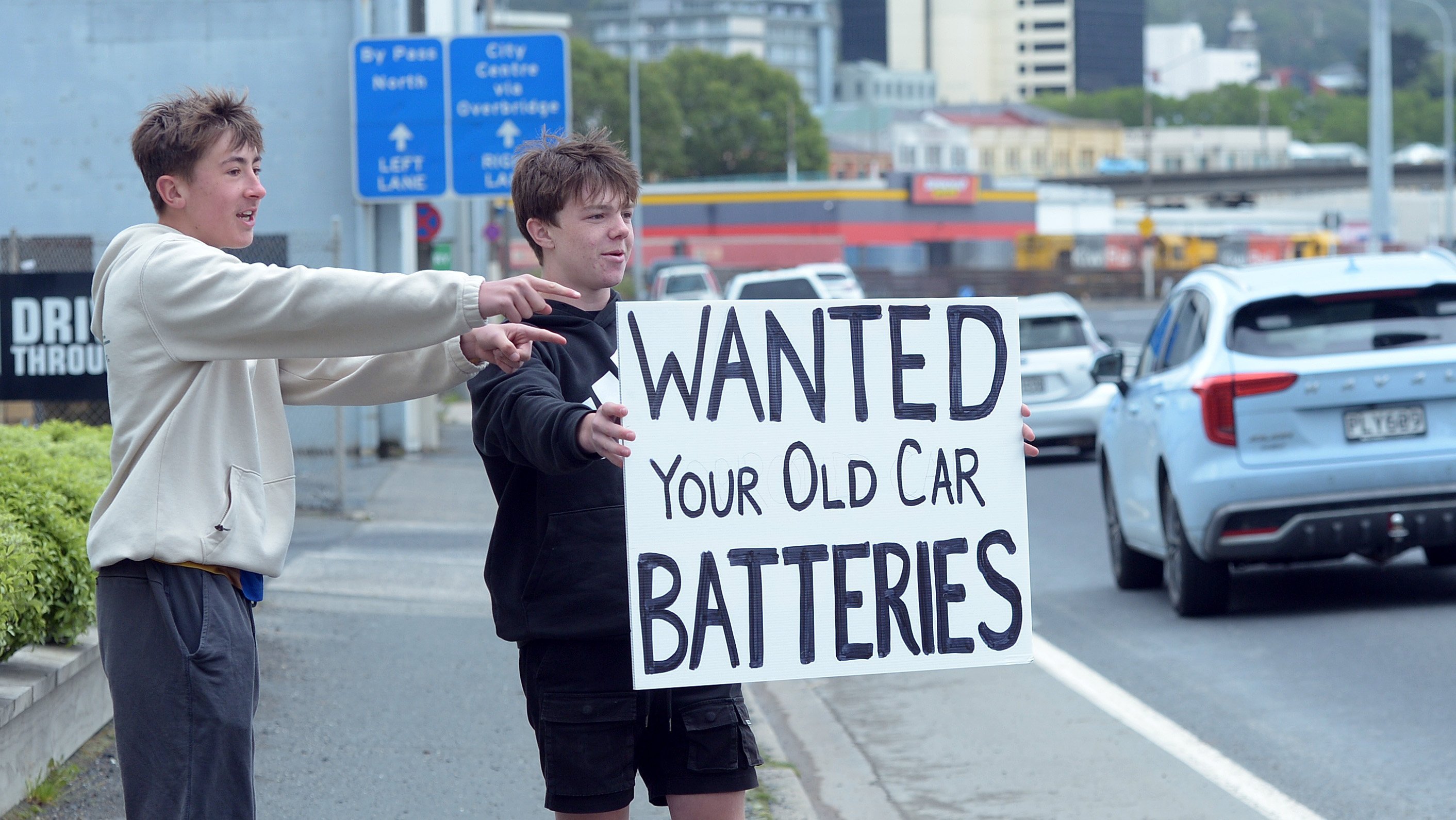 Taieri College students Harper Conley (left), 16, and Mace Hodge, 15, flash a sign in Portsmouth...