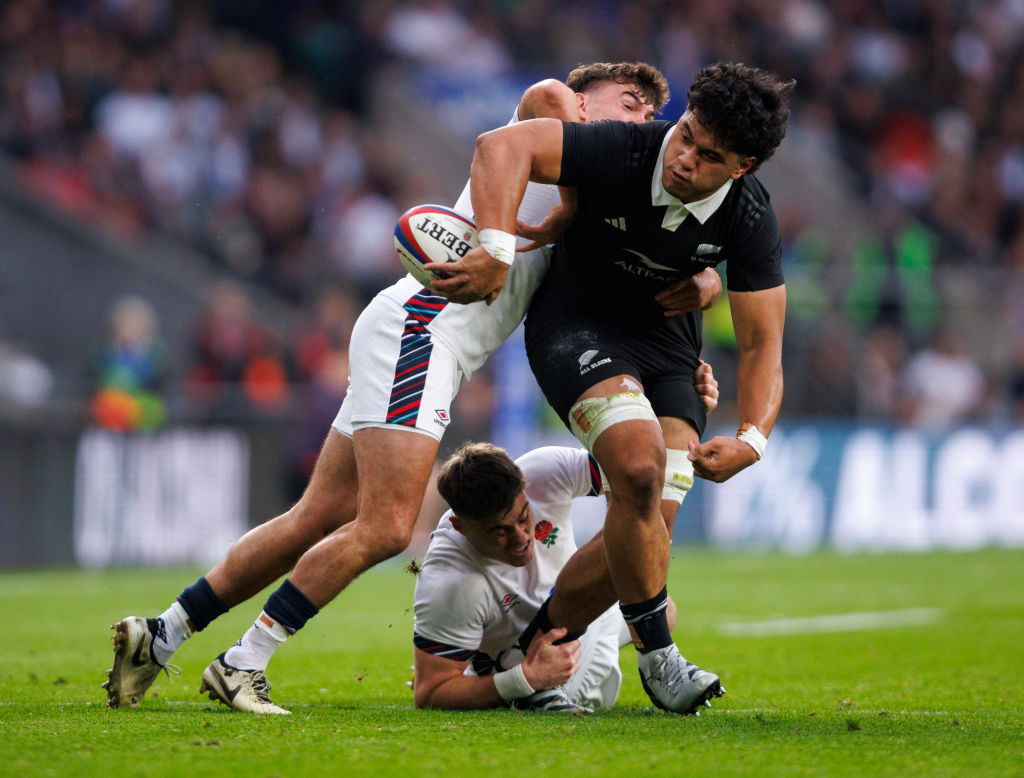 All Blacks flanker Wallace Sititi offloads during their game against England at Twickenham...