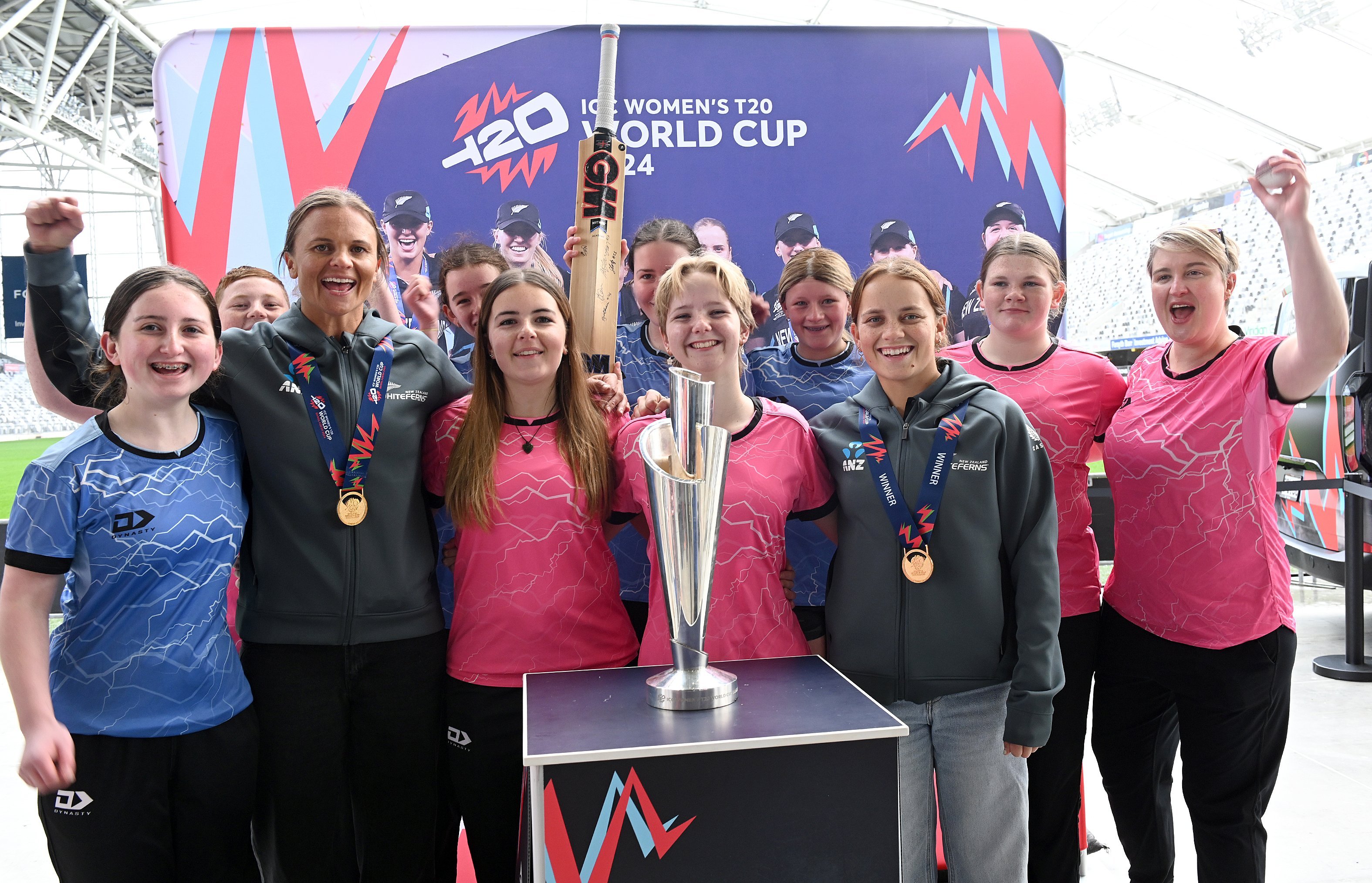 University Grange Cricket Club players gather around Women’s T20 World Cup-winning White Ferns...