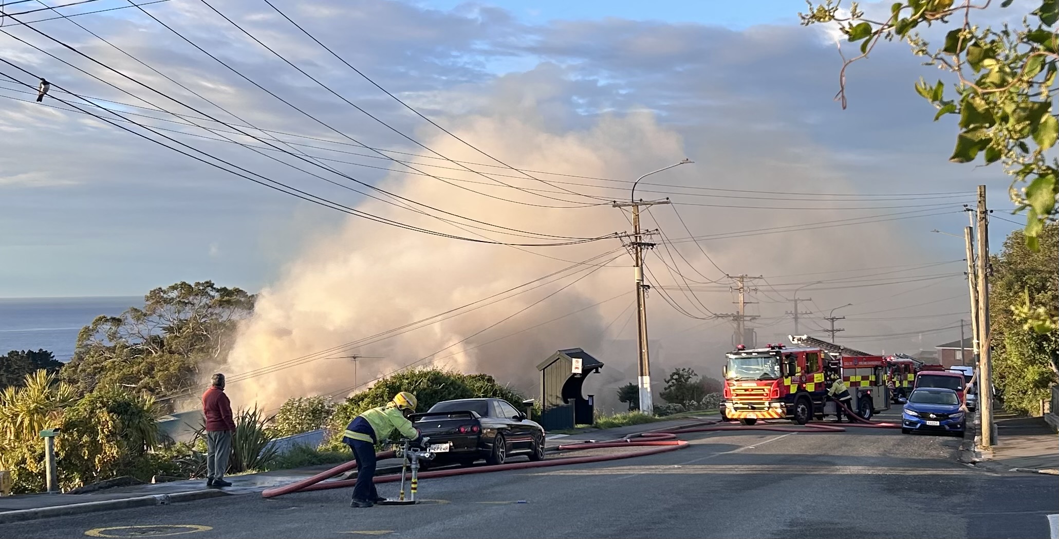 Firefighters at the scene on Highcliff Rd this morning. Photo: Stephen Jaquiery