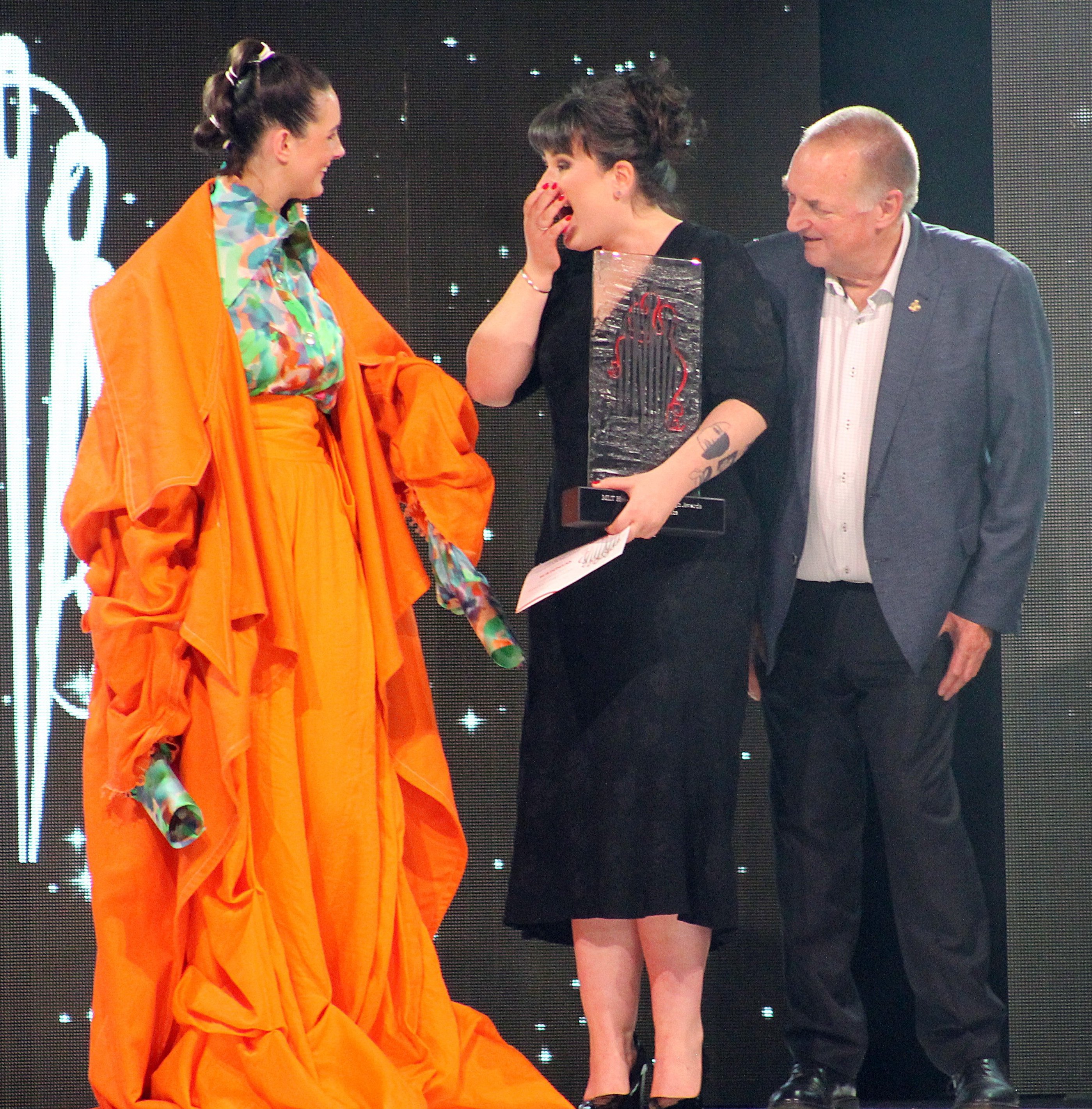 Tegan Rose Vickery (centre), receiving an award at the Hokonui Fashion Design Awards in July....