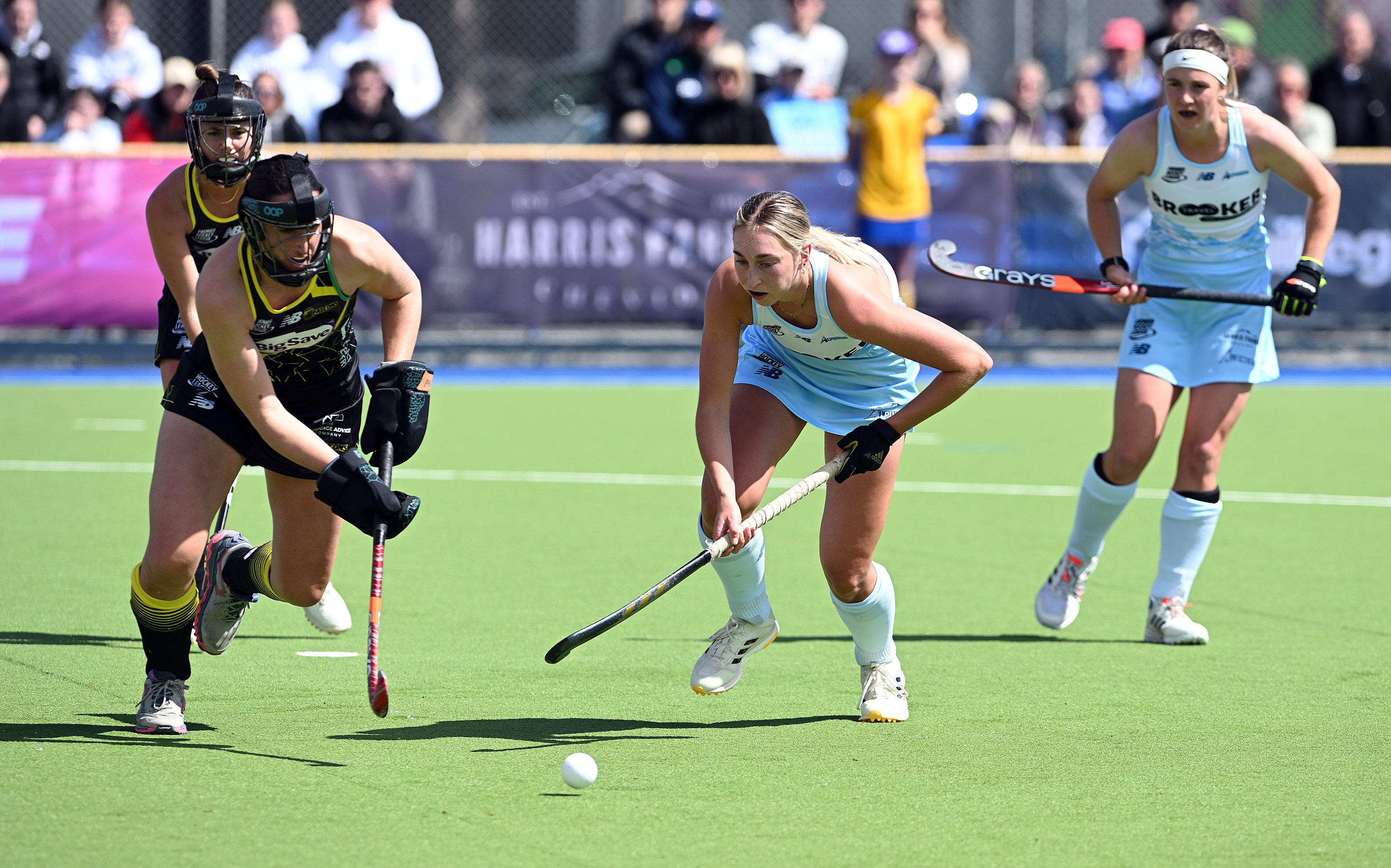 Falcons defender Stephanie Dickins charges down a penalty corner while Alpiners player Sophie...