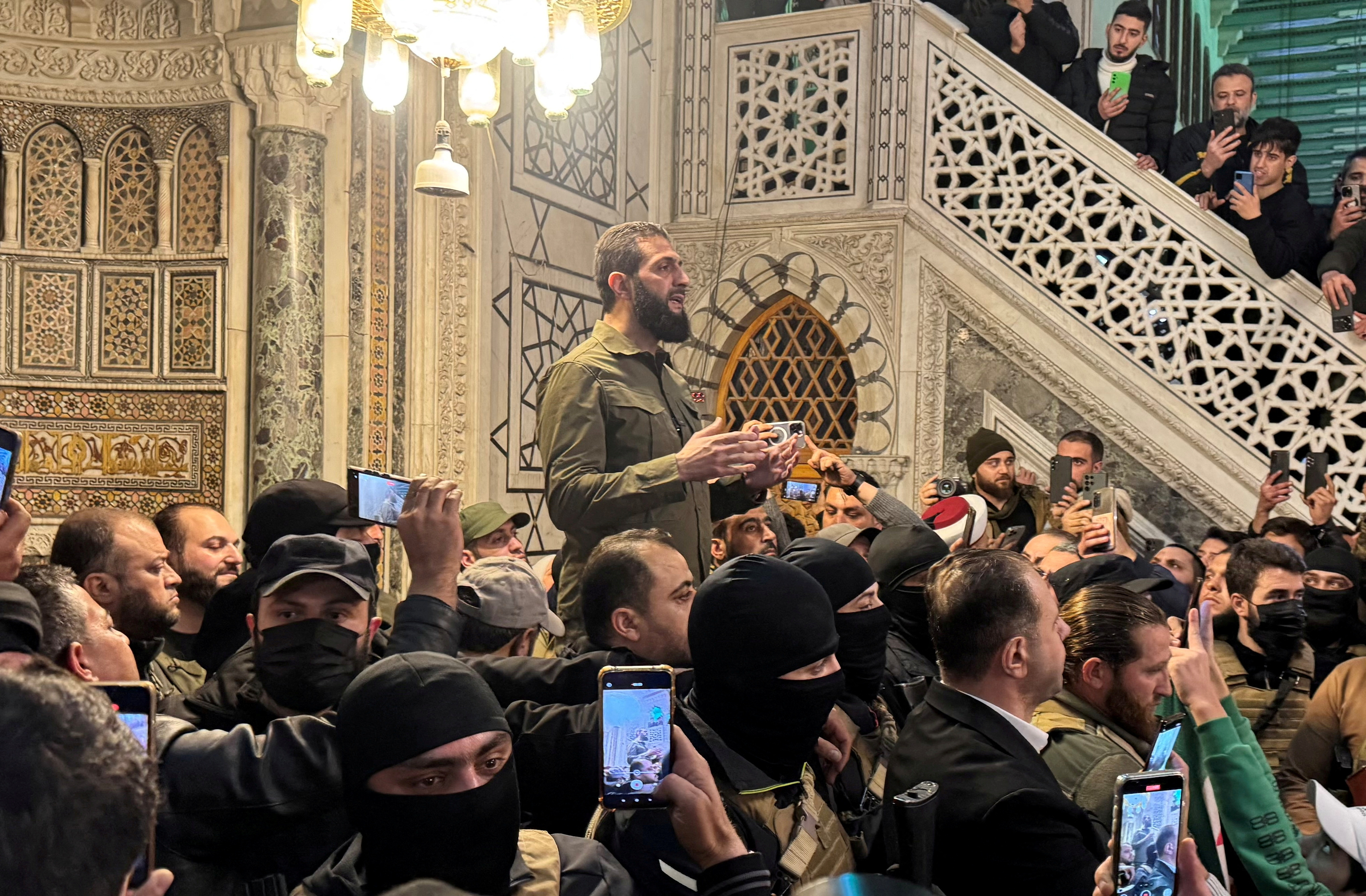 Rebel commander Abu Mohammed al-Golani speaks to a crowd at Ummayad Mosque in Damascus on Sunday...