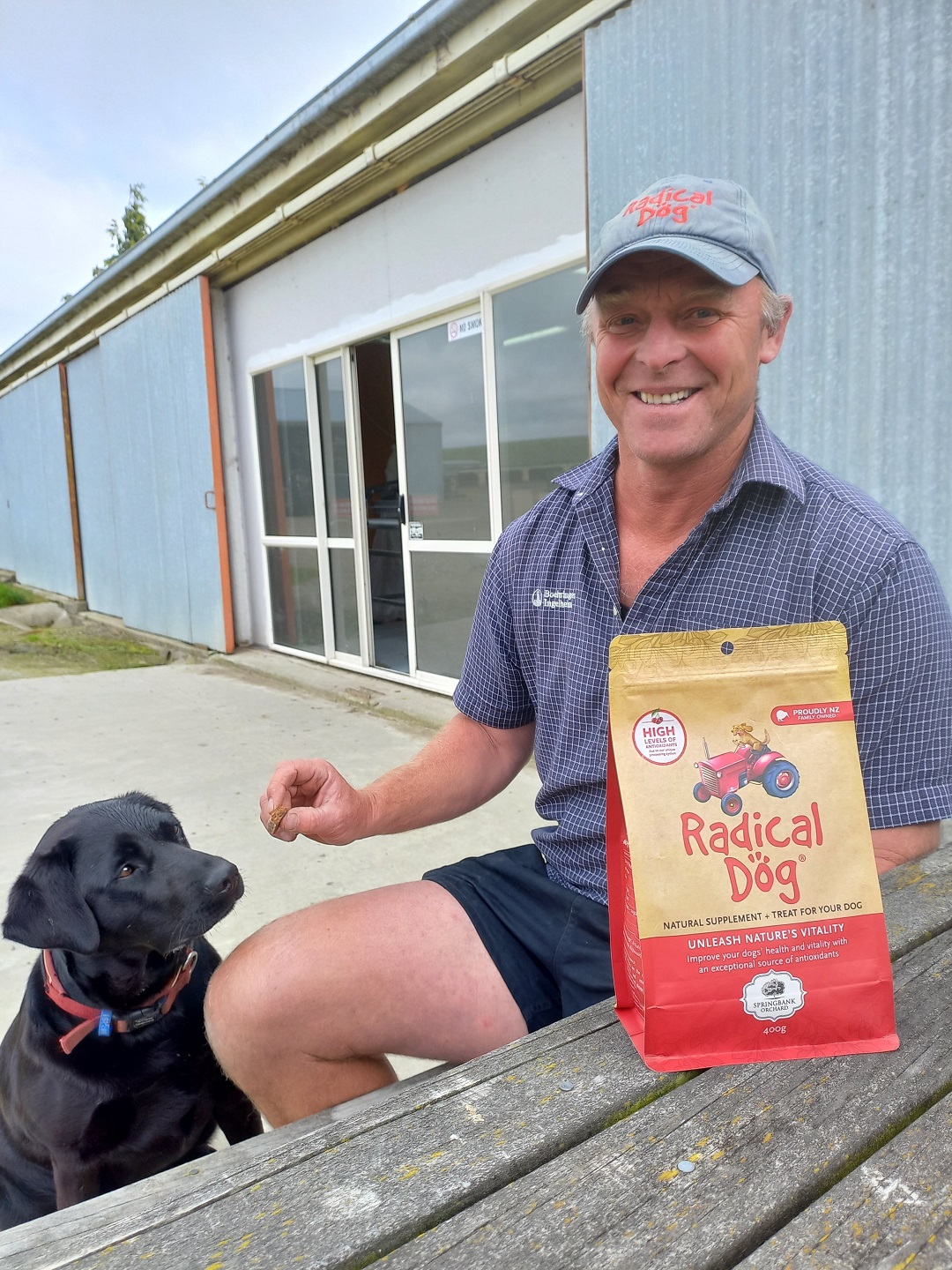 Snow (John) Newlands and Cookie the dog outside the Radical Dog factory on the Newlands family’s...