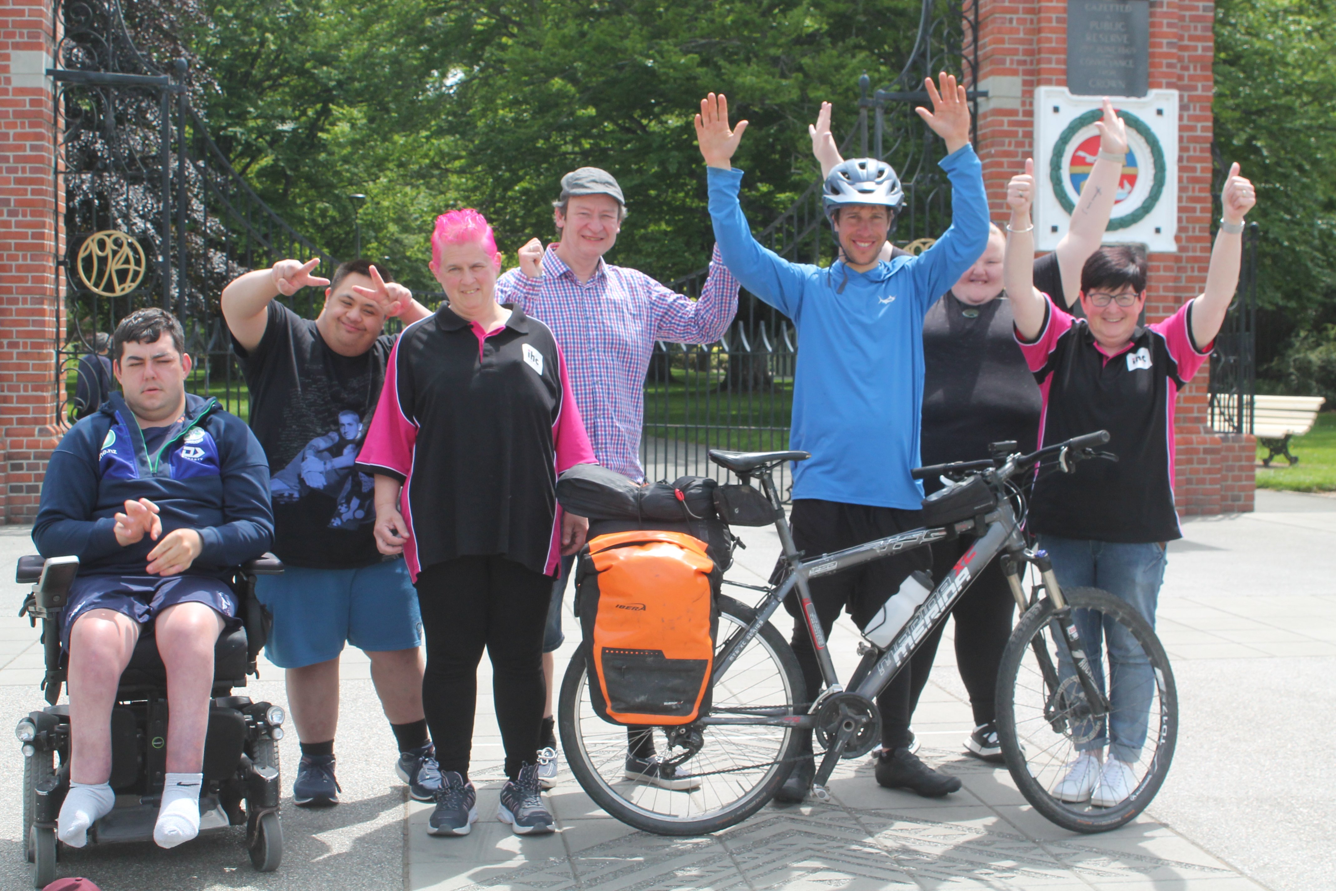 Jonathan Abplanalp stands behind his bike as he is welcomed by (from left) Jack Lovitt-Hurst,...