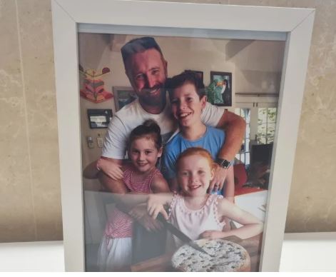 A photo of Kain Parsons and his children has been placed at the front of the room where the...