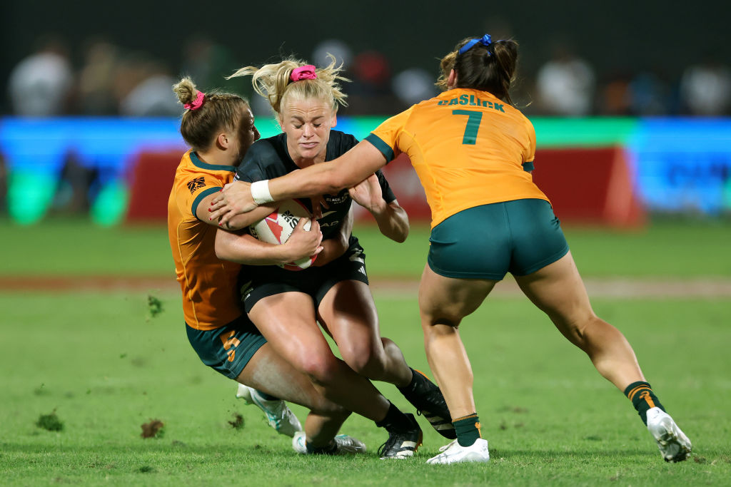 Black Fern Jorja Miller gets wrapped up in a tackle by Australia's Teagan Levi and Charlotte...