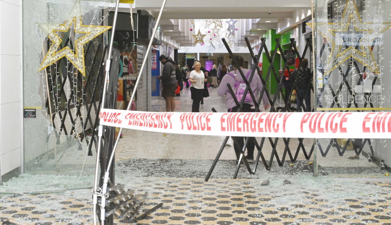 Store owners and Golden Centre staff assess the damage after an early morning ram-raid yesterday....