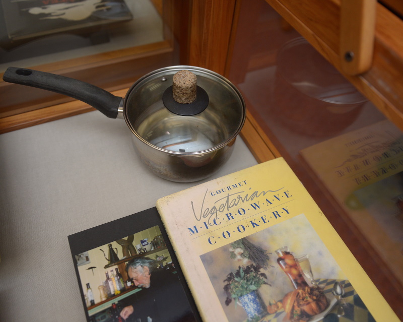 Hotere's mussel pot and a photograph of him cooking.