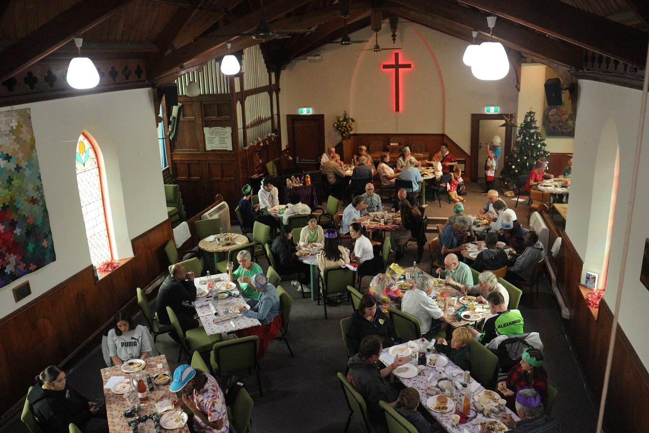 Local community members enjoying a Christmas feast at Saint Enoch’s Church in Alexandra. Photos:...