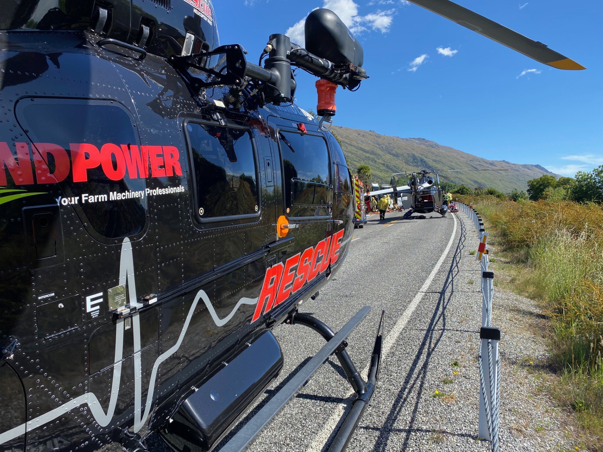 Helicopters sit at the scene of the fatal crash involving a bus near Kingston on Thursday. PHOTO:...