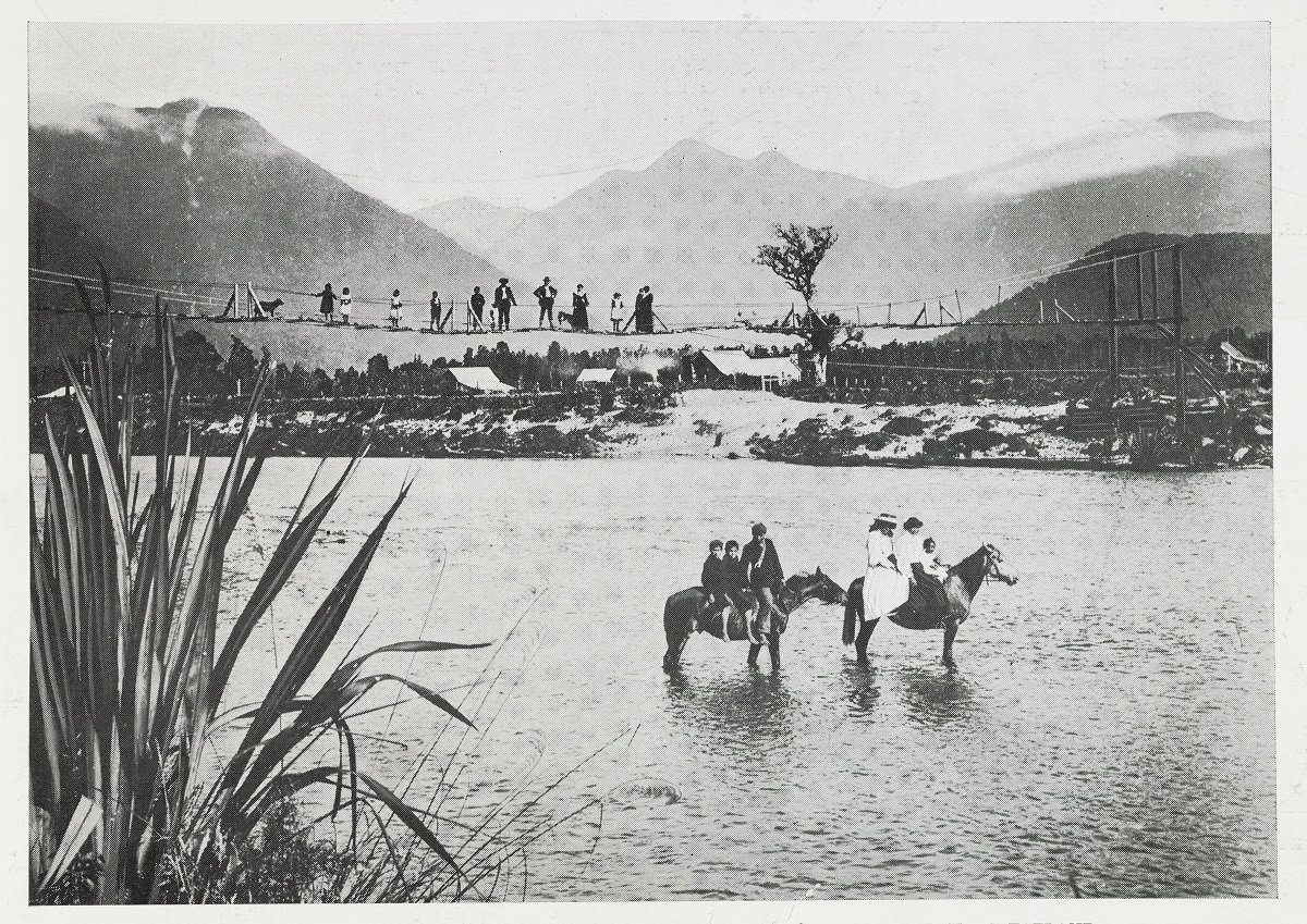 Local Māori pictured in 1910 with the foot swing bridge across the Makāwhio River just downstream...